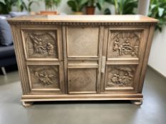 A 20th century Dutch heavily carved oak sideboard,