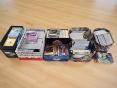 A large quantity of Pokemon and Yu-Gi-Oh! trading cards in tins.