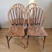 A set of four beech spindle back chairs.