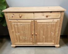 A 20th century pine and MDF double door side cabinet, 116 cm x 40 cm x 90 cm.