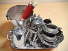 A group of stainless steel tea wares, an ice bucket, a hammered pewter milk jug and sugar bowl,