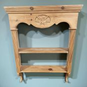 A carved pine wall rack, width 62 cm.