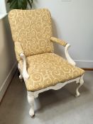 A painted armchair in gold upholstery.