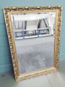 A gilt and bevelled mirror, 104 cm x 75 cm.
