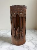 A Chinese carved bamboo cylindrical scroll pot with lid, height 23 cm.
