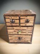 A late 19th century Japanese parquetry four drawer miniature chest, height 15 cm.