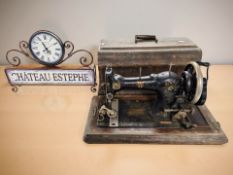 An antique Federation hand sewing machine and a French battery operated timepiece.