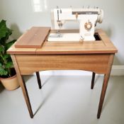 A Jones 641 electric sewing machine in teak table.