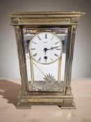 A brass cased Acctim eight day mantel clock, with pendulum and key, height 29 cm.