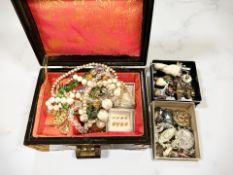 A group of costume jewellery, various brooches and bead necklaces,