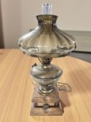 A contemporary table lamp in the form of an oil lamp, height 58 cm.