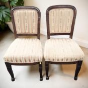 A pair of continental mahogany salon chairs on paw feet.