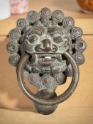 A cast bronze door knocker, length 21 cm.
