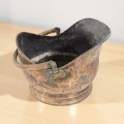 A Victorian copper coal helmet.