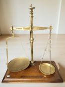 A large set of W & T Avery Limited mahogany and brass balance scales, width 51 cm.