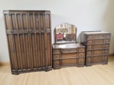 A 20th century oak three piece bedroom suite comprising double door wardrobe,