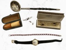 A toddy ladle with wrythen-horn handle, a cheroot, synthetic ruby bracelet,