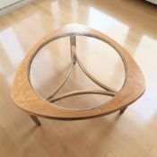 A Nathan teak and glass inset coffee table, diameter 77 cm.