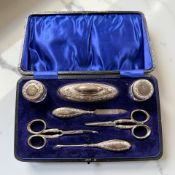 A cased silver-mounted vanity set, Birmingham marks.