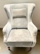 A 20th century wingback armchair in green draylon upholstery.