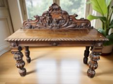 A 19th century continental heavily carved oak serving table, 156 cm x 52 cm x 130 cm.