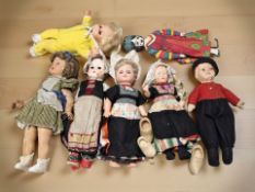 An early 20th century papier mache jointed doll and several other later dolls