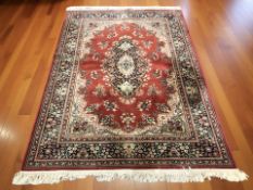 A machine made rug of Iranian design, 205 cm x 137 cm.