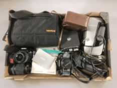 An Olympus OM40 Program camera body with OM-System F=50mm lens,