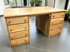 A modern pine twin pedestal partner's desk, 150 cm x 90 cm x 76 cm.