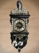 A reproduction continental silvered wall clock with pear drop weights, height 67 cm.
