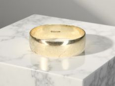 A 9ct gold band ring