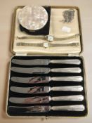 A cased set of six silver-handled butter knives, together with a marcasite brooch,