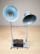 A large pair of enameled metal adjustable speakers on stand raised on castors, height 160 cm,