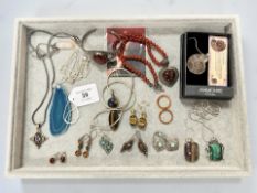 A group of silver/white metal jewellery including an ammonite fossil pendant, earrings,