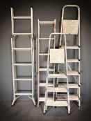 Four aluminium ladders.
