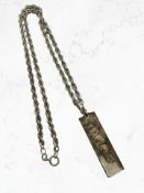 A silver ingot on silver rope-twist chain
