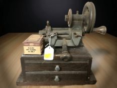An antique Yale key cutting machine and a box of Union key blanks.