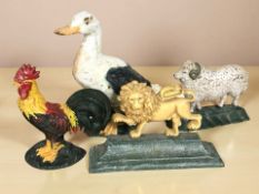 Four painted cast iron door stops in the form of animals, tallest 30 cm.