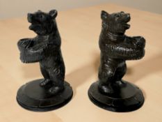 A pair of Black Forest style carved and stained wooden pen stands in the form of bears, height 11.