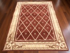 A machine made rug on red ground,