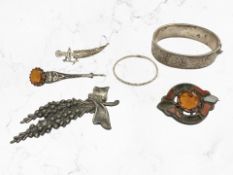 An antique silver bangle, together with Scottish hardstone brooch,