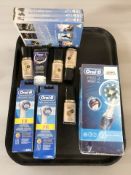 An Oral B Pro 2 electric toothbrush, two further packs of replacements heads in retail packaging,