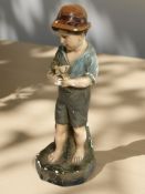 A Continental plaster figure of a boy holding a dove,