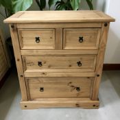 A modern pine four drawer chest.