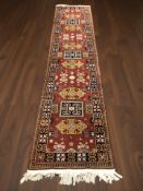 A Caucasian runner of geometric design, 350 cm x 77 cm.