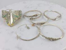 A group of silver/white metal bangles,