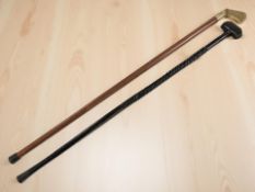 A walking stick with brass golf club handle, and a further walking stick.
