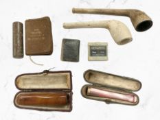 A group of antique clay pipes,