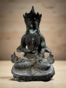 A 19th century Tibetan patinated metal statue of Buddha in lotus pose,