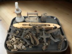 A pair of early 20th century spiked metal shoe ice grips, together with a brass bell weight,